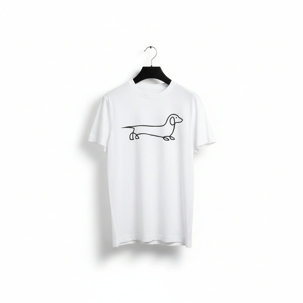 A white short-sleeve crewneck t-shirt hanging on a black hanger against a light-colored wall. The shirt features a minimalist black line art drawing of a dachshund across the chest.