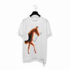A white short-sleeve crewneck t-shirt hanging on a black hanger, featuring a stylized graphic of a horse in orange, brown, and black concentric shapes with a black line drawing of reins.